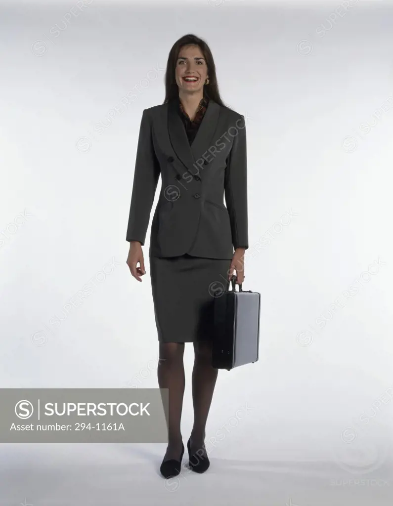 Portrait of a businesswoman holding a briefcase and smiling