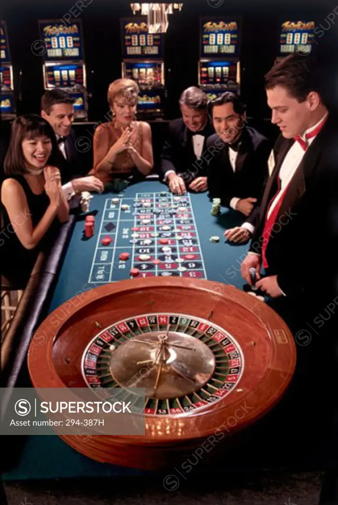 Group of people playing roulette in a casino
