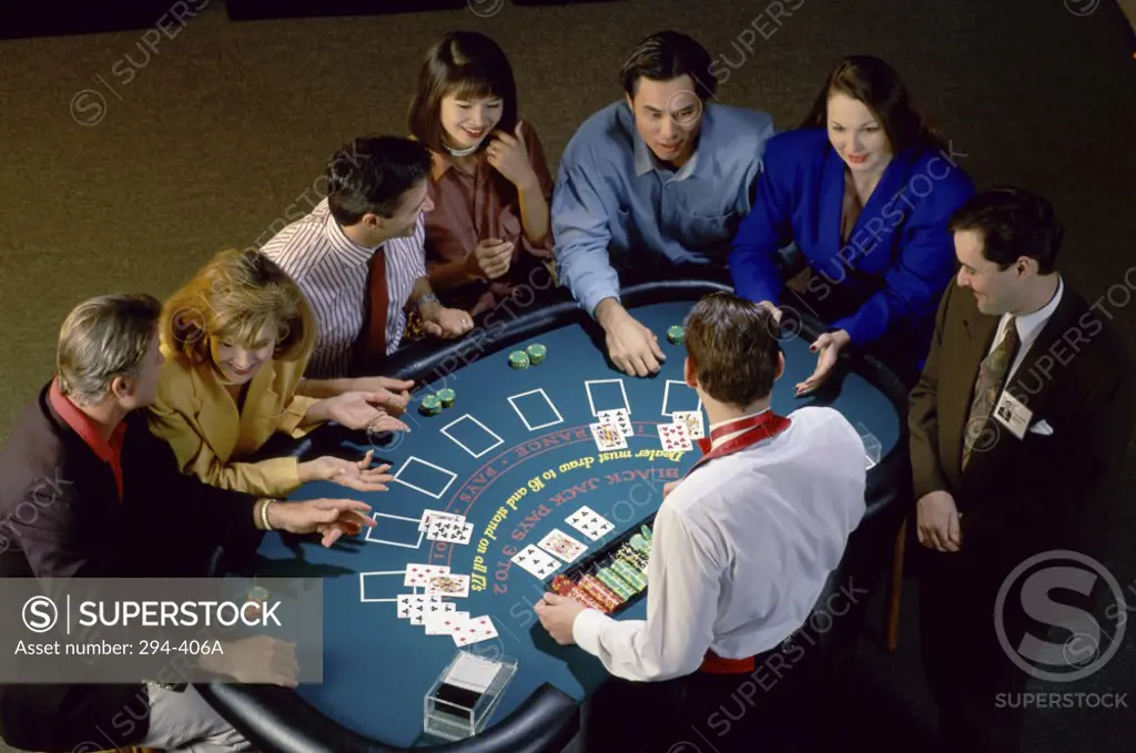 High angle view of a group of people playing blackjack in a casino