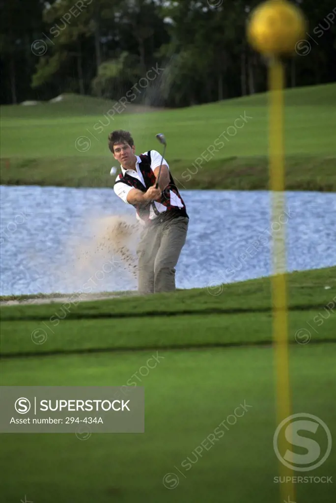 Mid adult man playing golf