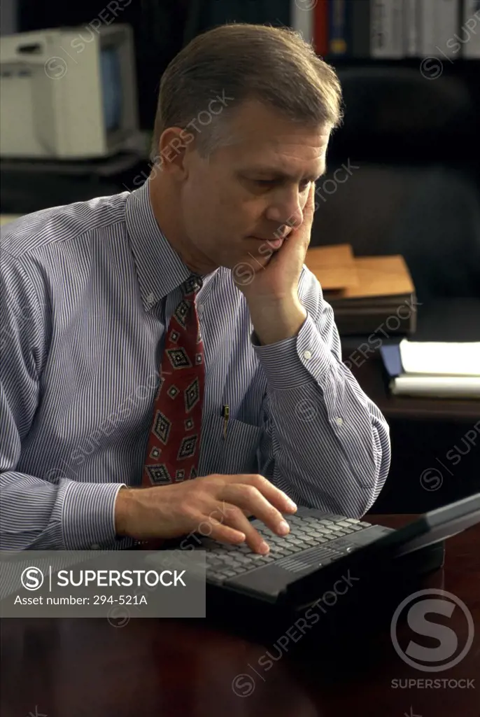 Businessman using a laptop in an office