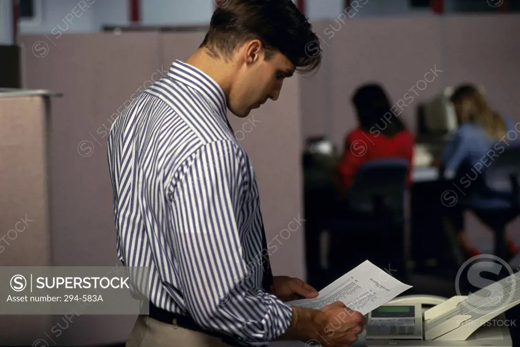 Businessman reading a document in an office