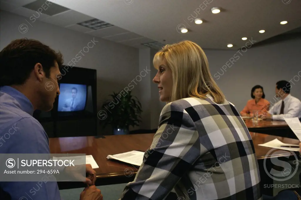 Businessman and a businesswoman talking in a video conference