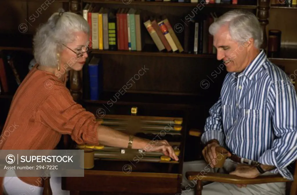 Senior couple playing backgammon