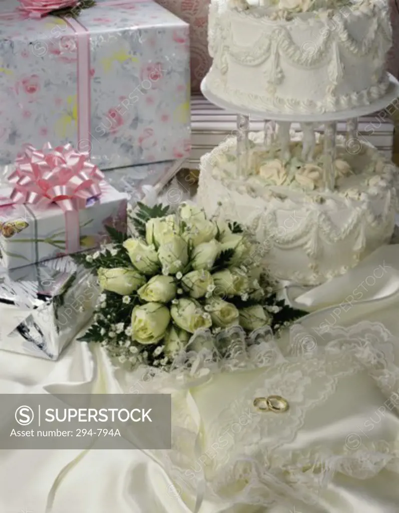 Cake with rings and gifts on a sheet