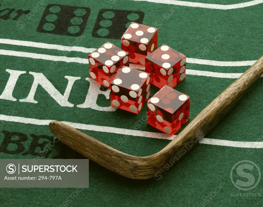 Close-up of dice with a croupier stick on a craps table