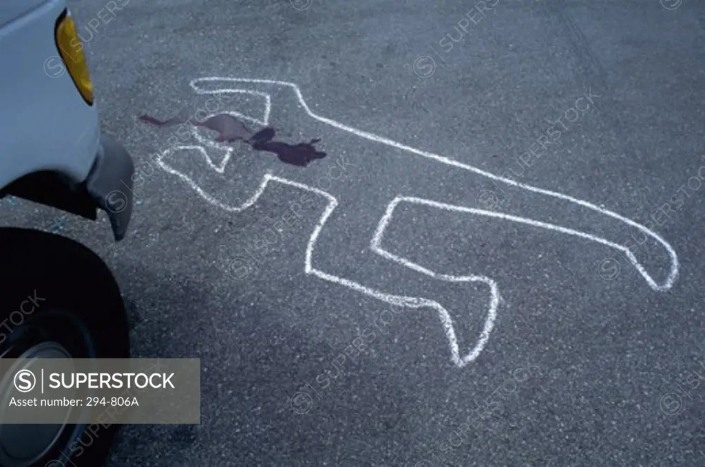 High angle view of the chalk outline of a human body on the road