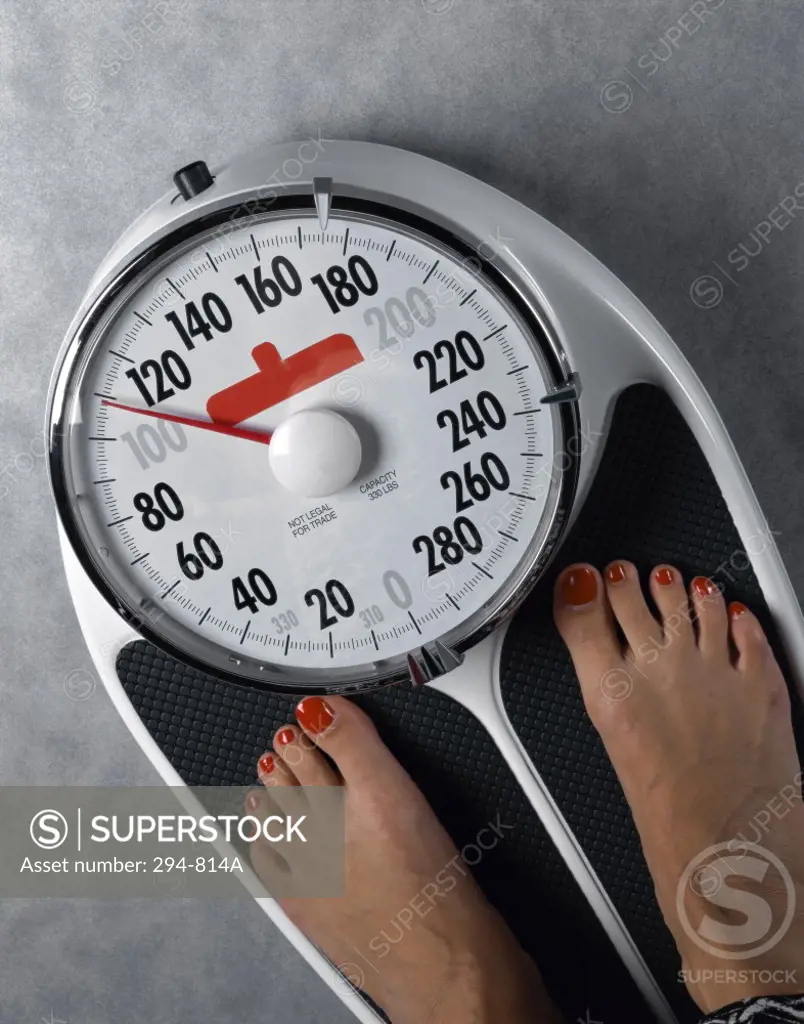 High angle view of a woman's feet on a weighing scale