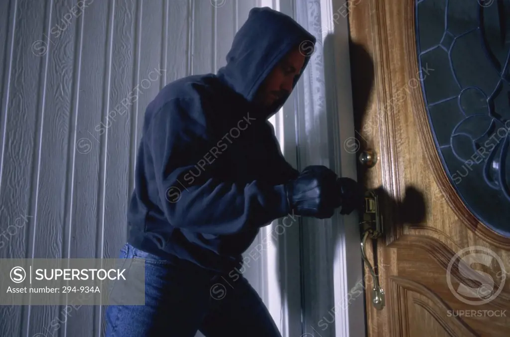 Thief breaking into a house