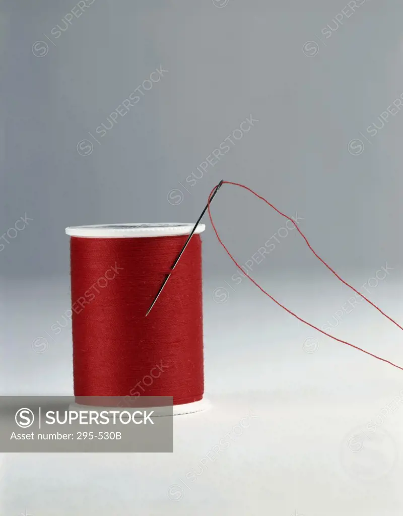 Close-up of a spool of thread with a needle