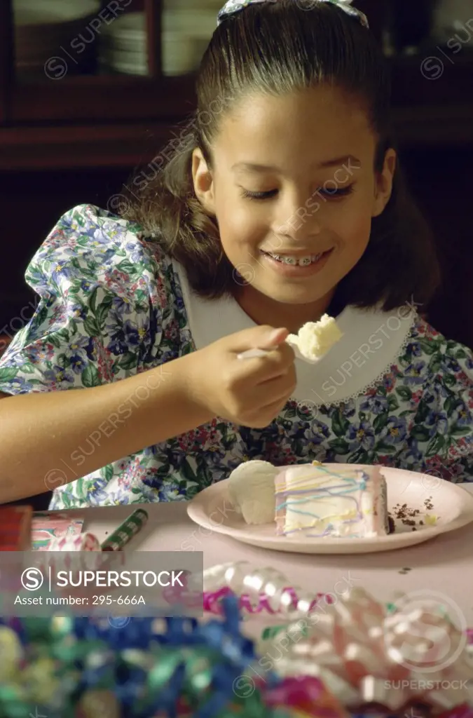 Close-up of a girl eating a birthday cake