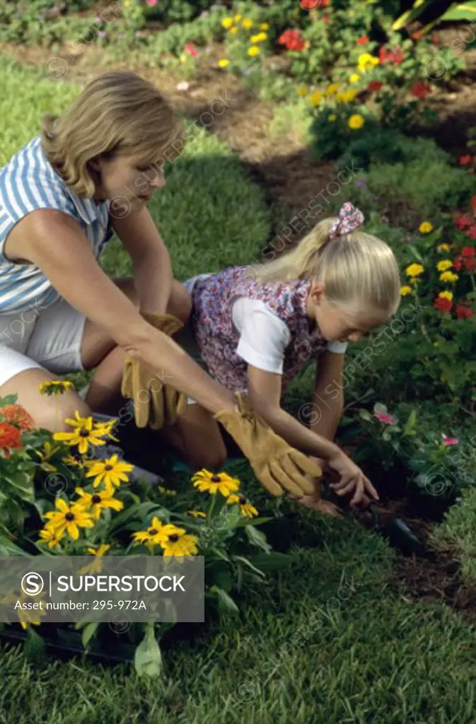 Mid adult woman gardening with her daughter