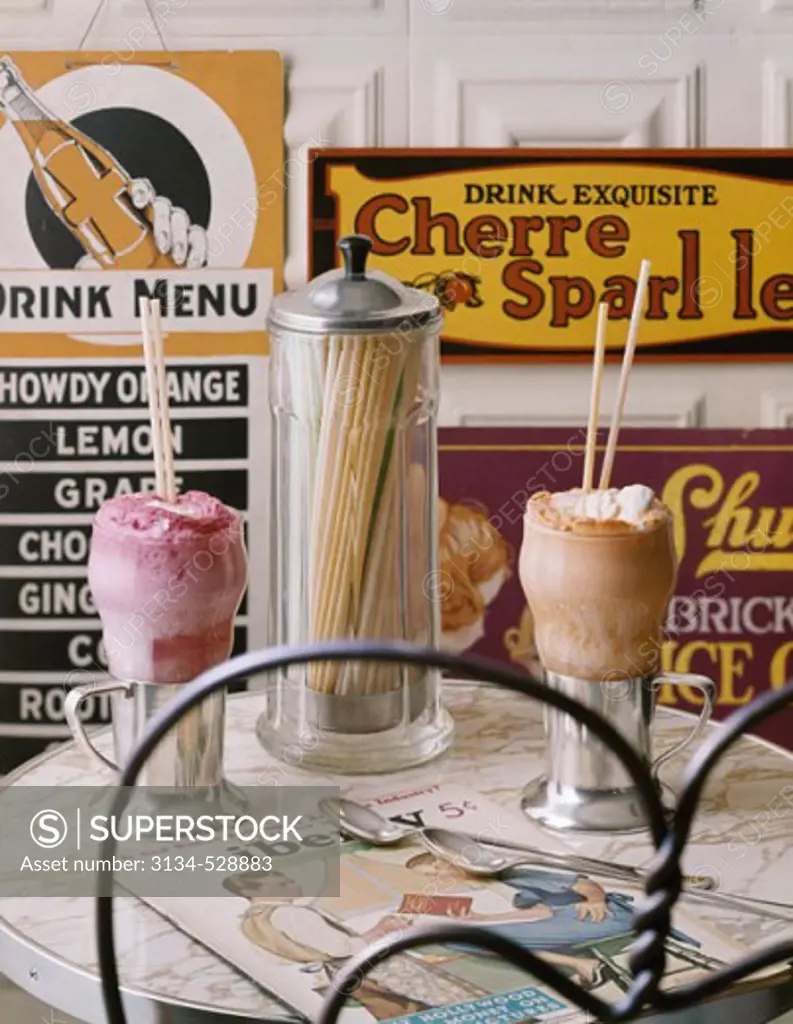 Close-up of two glasses of ice cream and a jar on a table