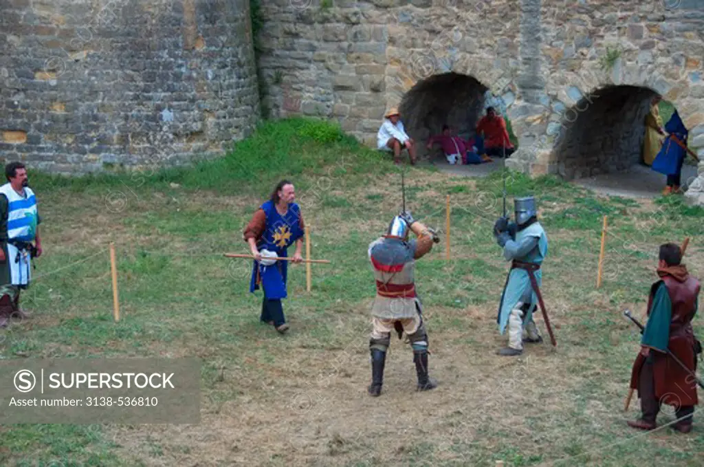 People in warriors' costumes in a fortress, Carcassonne, Aude, Languedoc-Rousillon, France