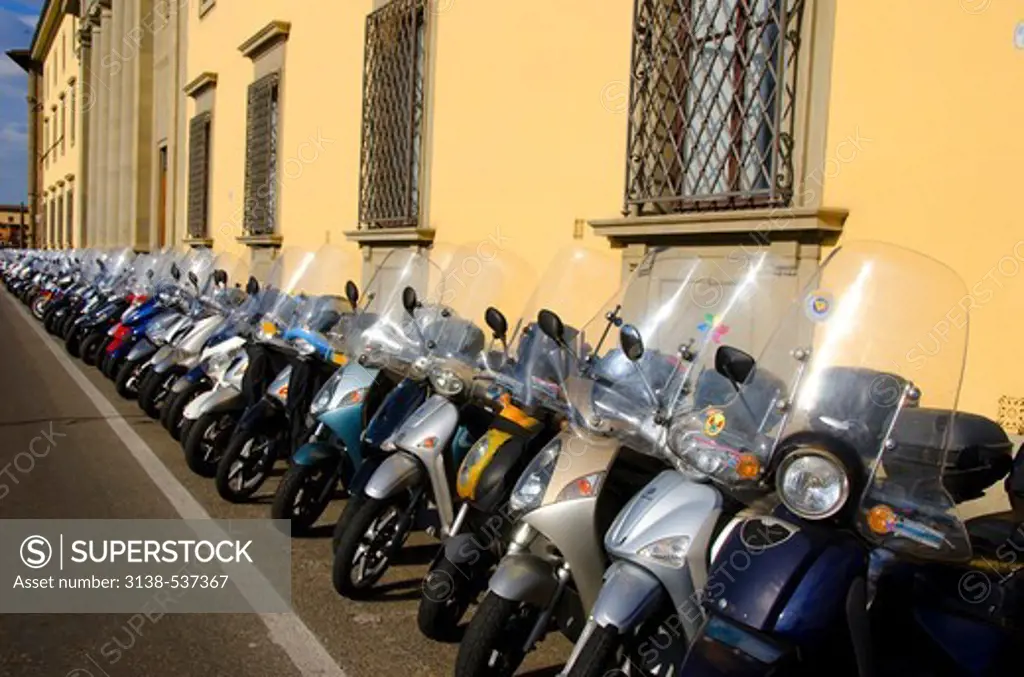 Motorcycles and scooters parked outside a museum, Uffizi Museum, Florence, Tuscany, Italy