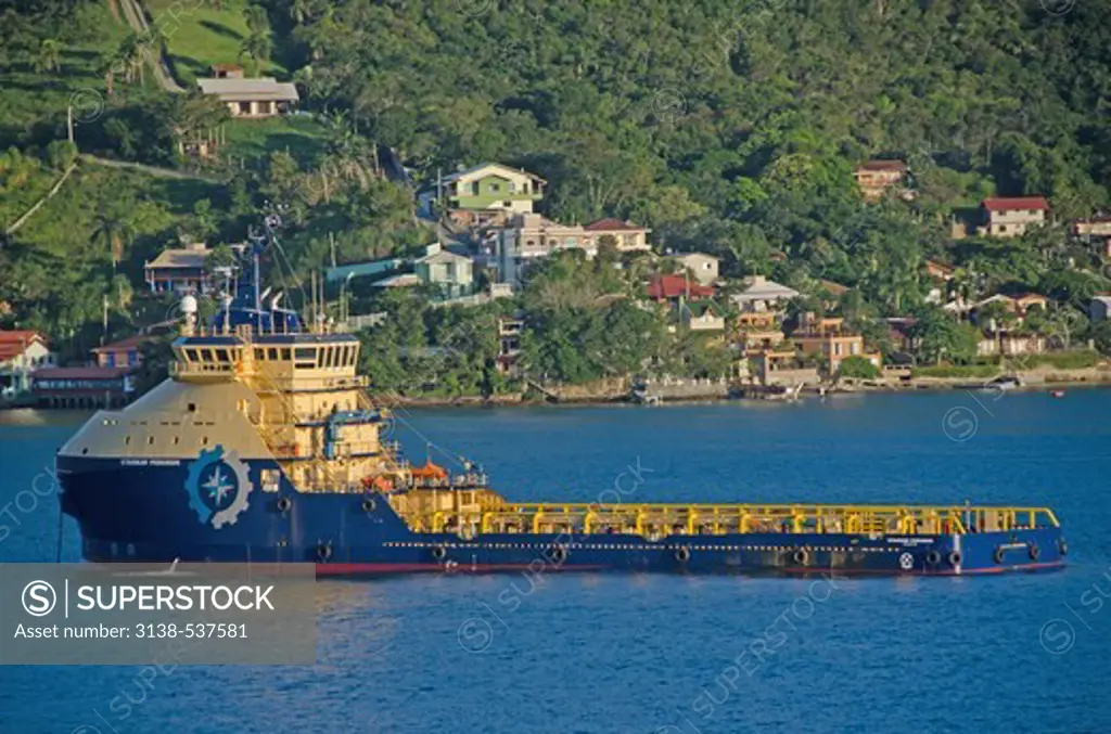 Oil rig supply ship with town in the background, Porto Belo, Santa Catarina, Brazil