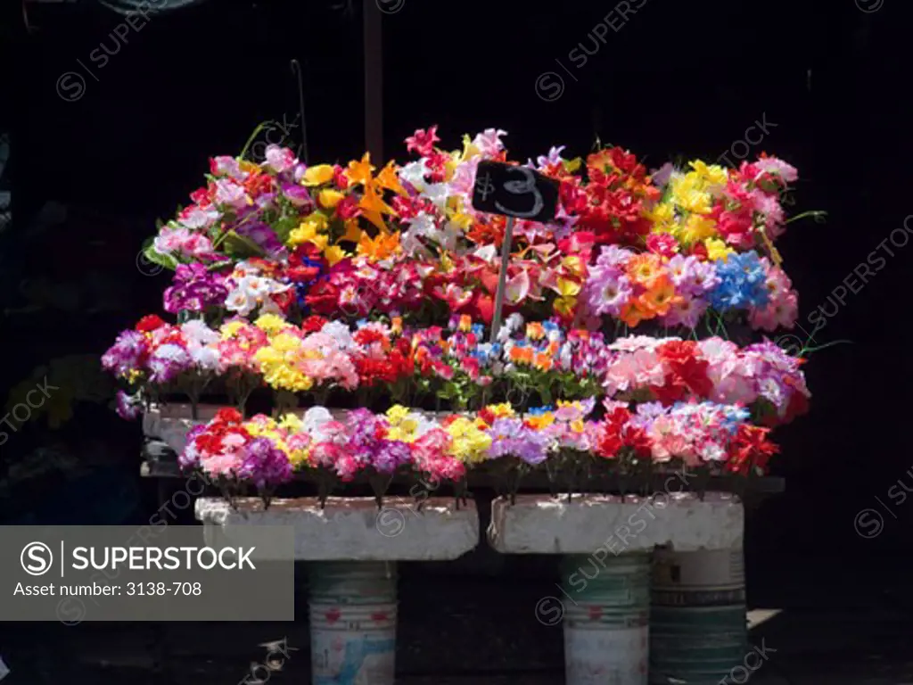 Close-up of artificial flowers at a market stall