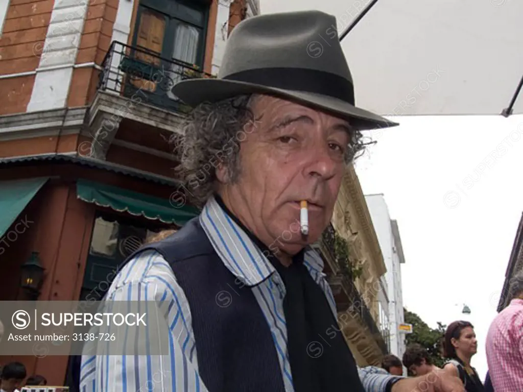 Mature man smoking a cigarette, Buenos Aires, Argentina