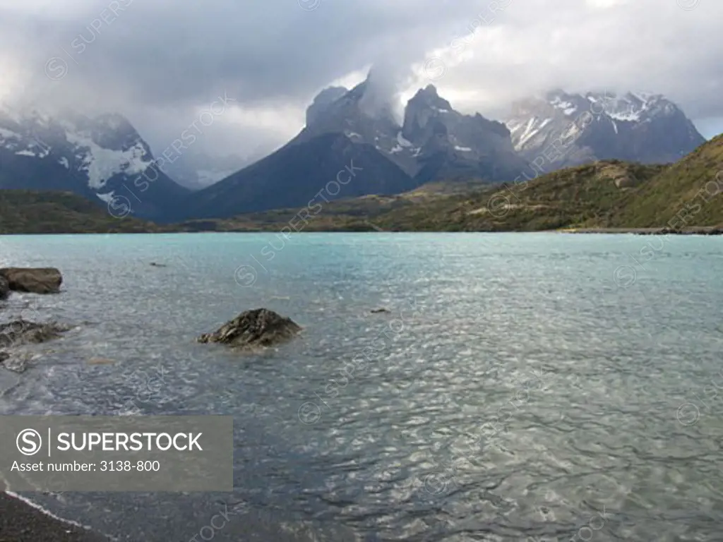 Clouds over a lake with mountains in the background, Lake Pehoe, Cuernos Del Paine, Torres del Paine National Park, Patagonia, Chile