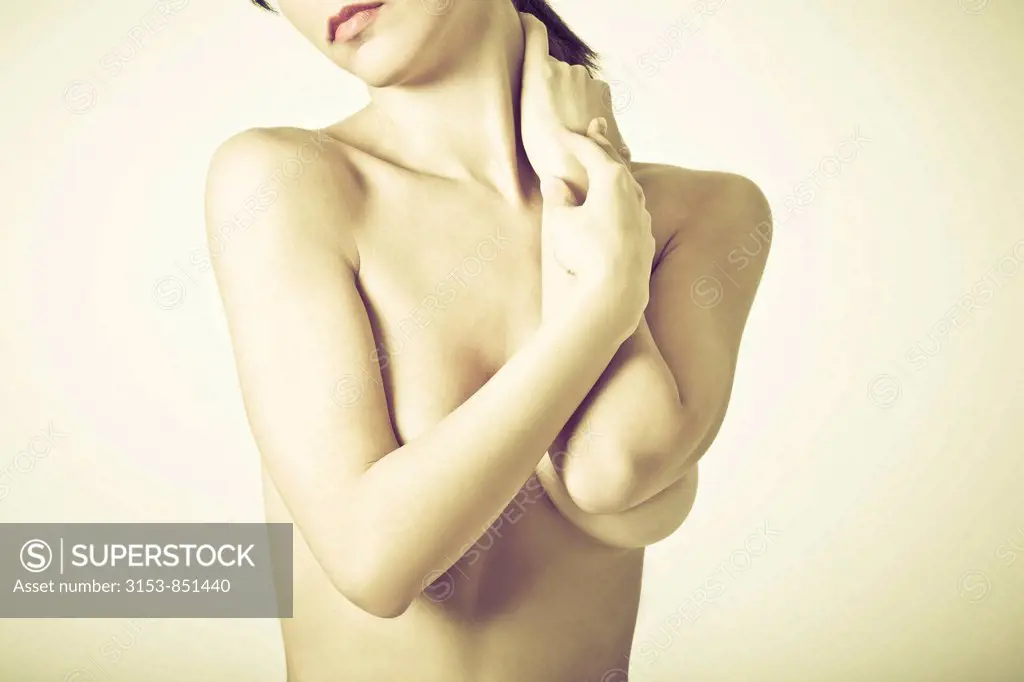 young woman with hands on neck