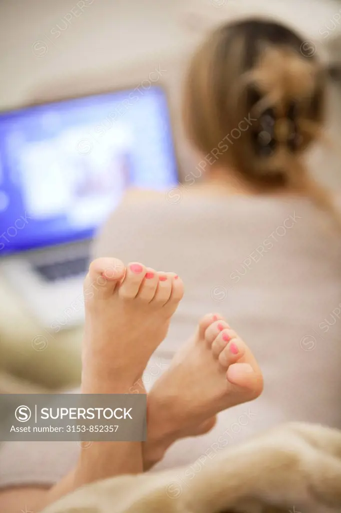 feet of a woman at computer