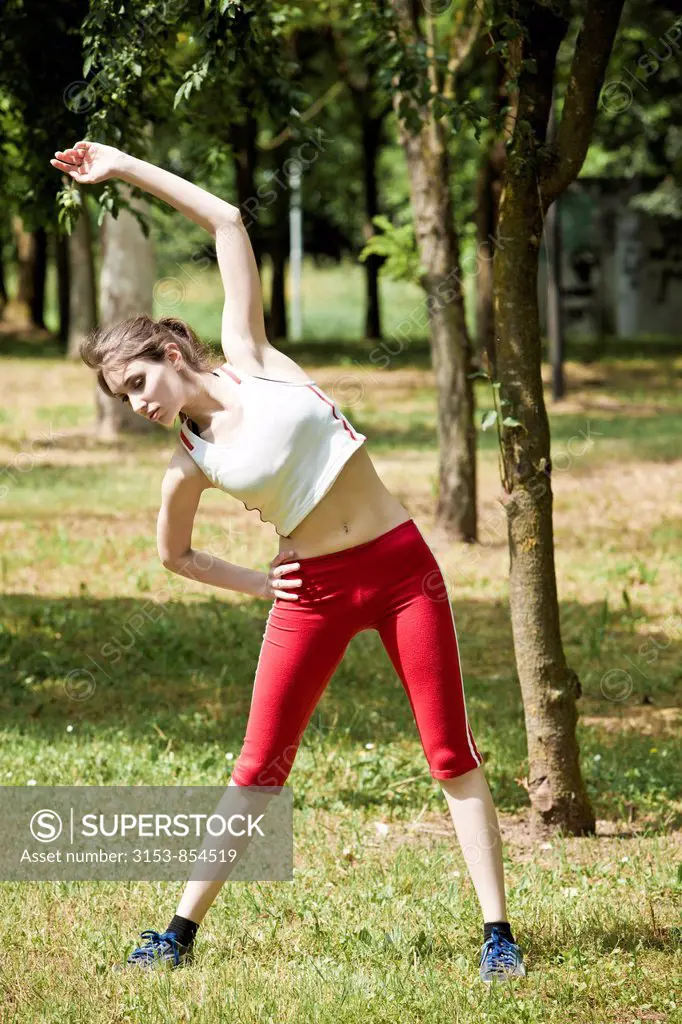 woman stretching at the park