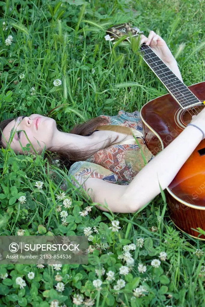 young woman palying guitar