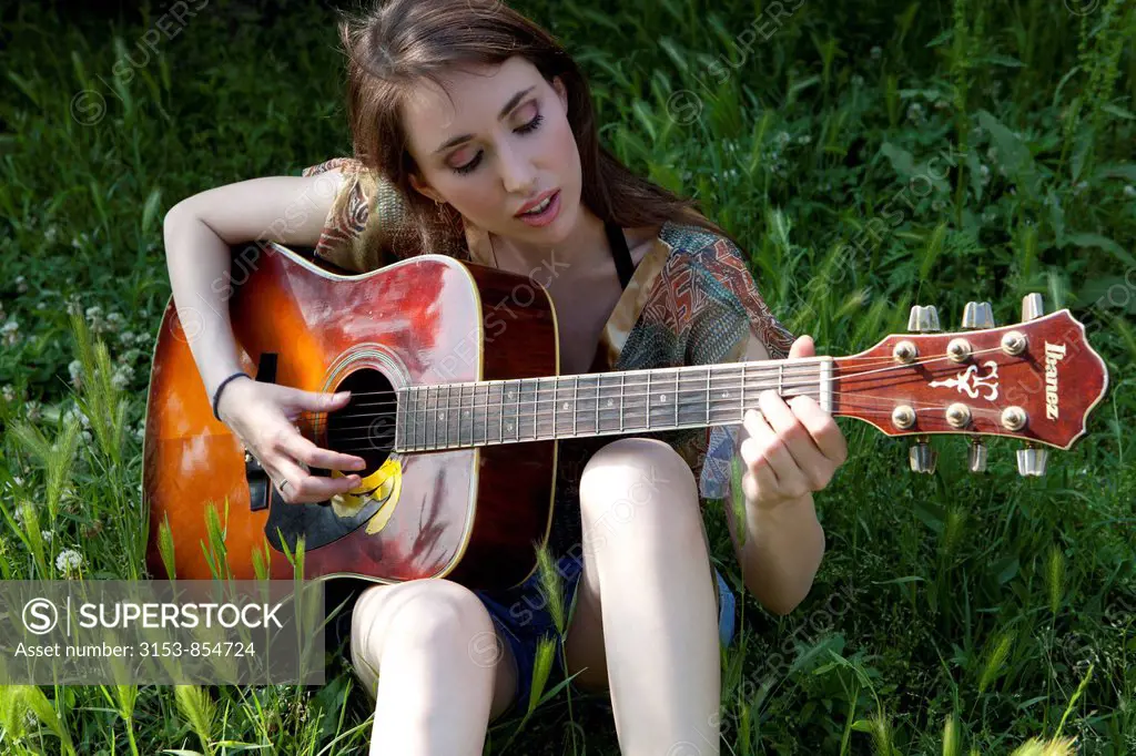 young woman palying guitar