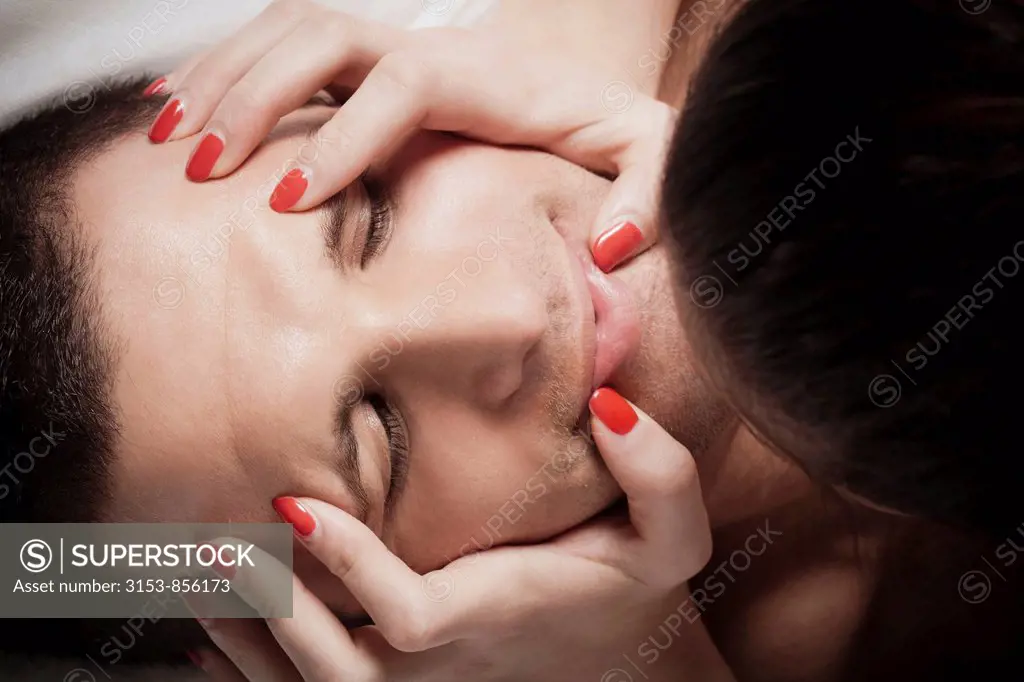 hands of a woman on the face of a man