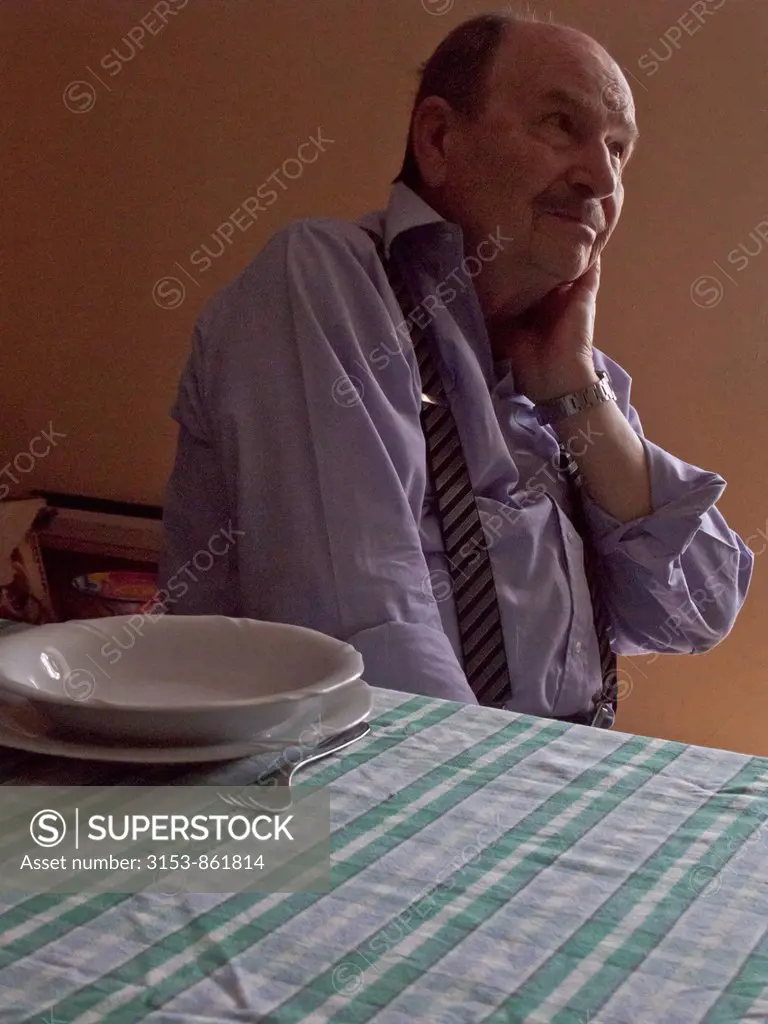 elderly man seated at the table