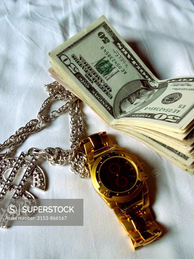 dollari e orologio d´oro, simboli di ricchezza