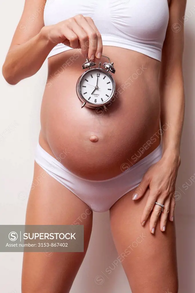 pregnant woman with alarm clock