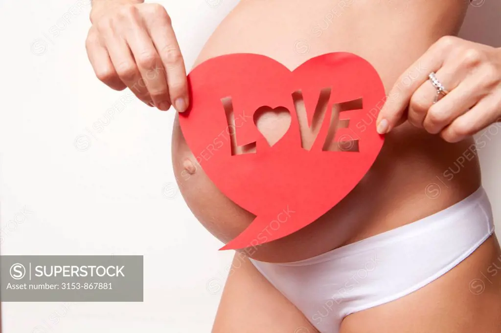 pregnant woman with written love