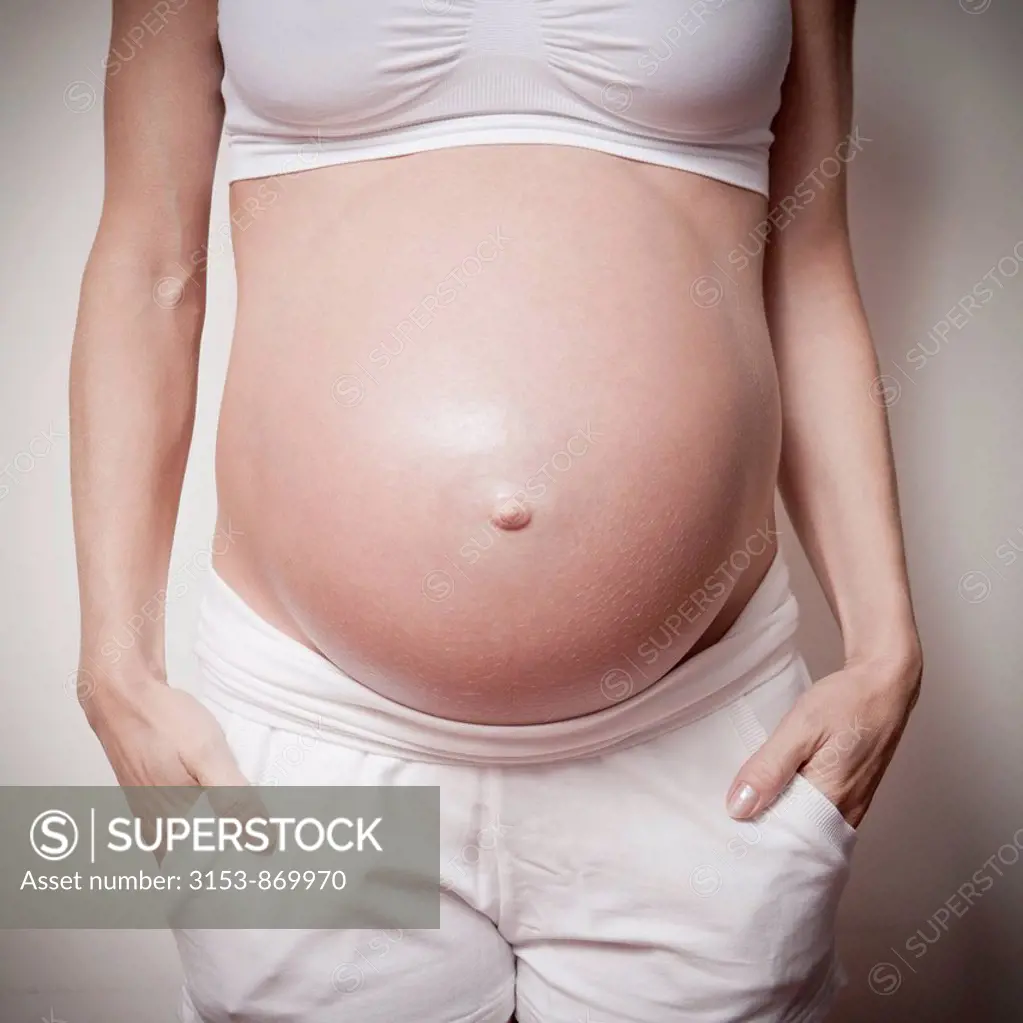 pregnant woman with hands in pockets