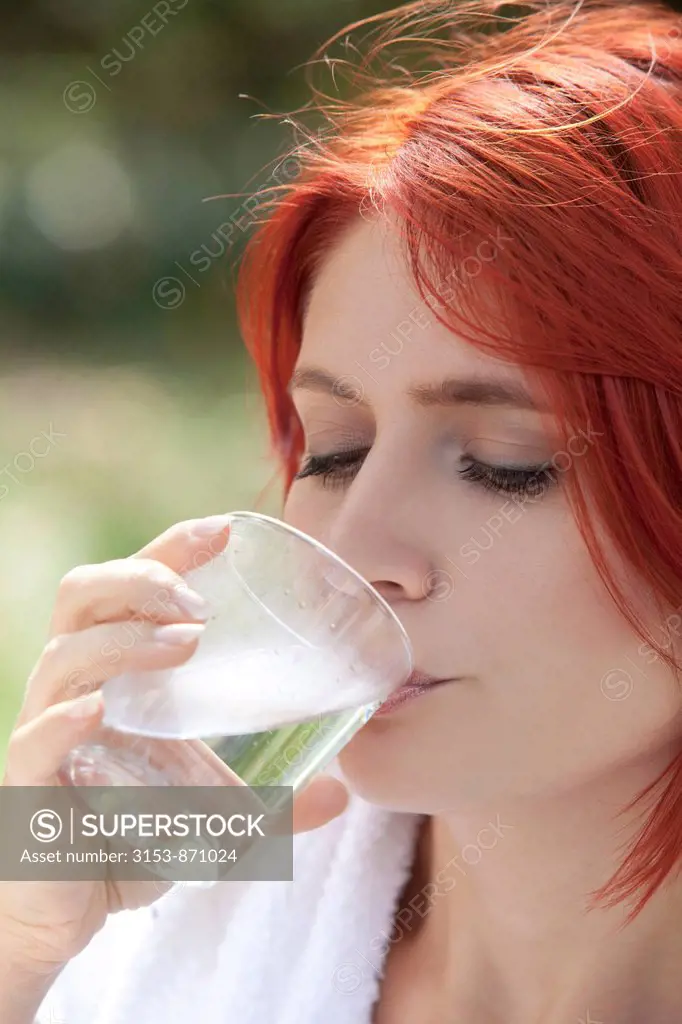 young woman drinking a glass of water
