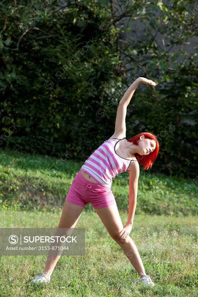 woman does gymnastics outdoors
