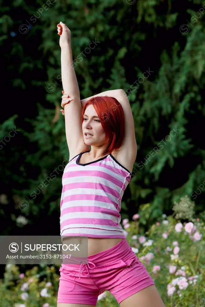 woman does gymnastics outdoors