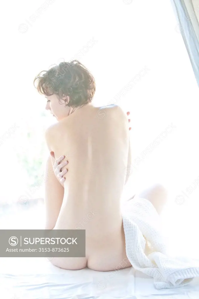 naked woman sitting behind