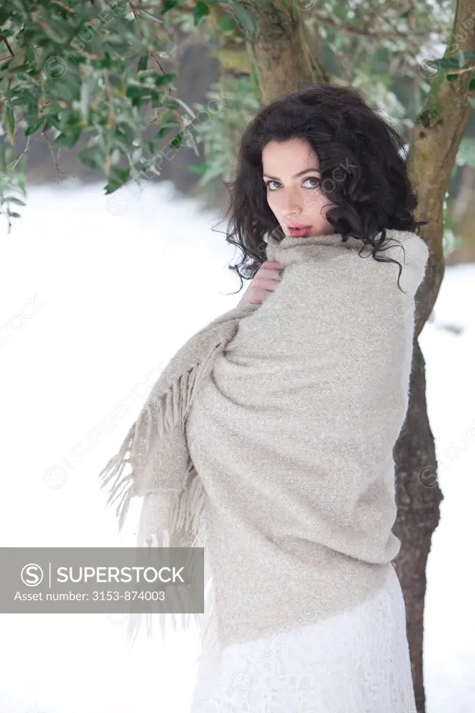 woman shivering with a blanket in the country