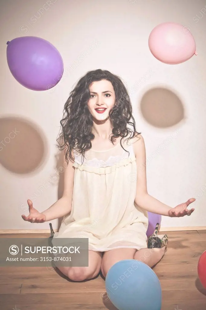 woman on the floor with colorful balloons