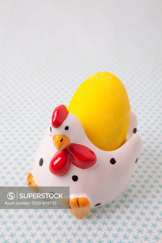 chicken ceramic egg cup with yellow sugar easter egg