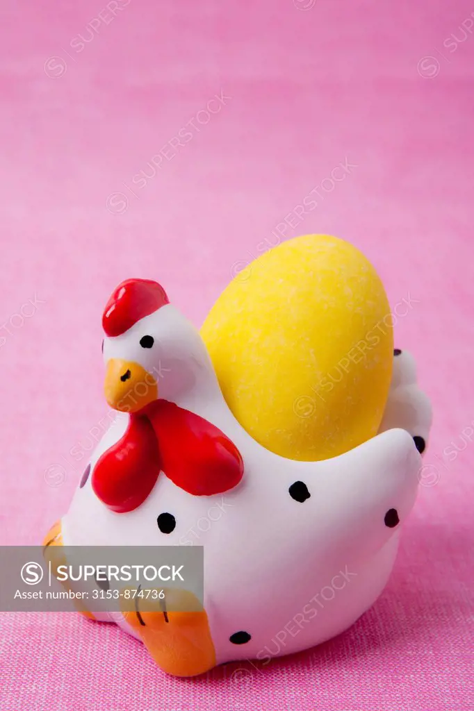 chicken ceramic egg cup with yellow sugar easter egg