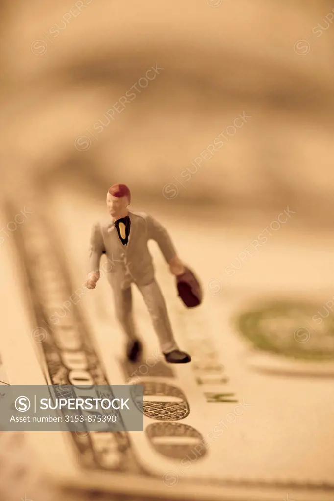 figure of businessman on 100 dollars banknote