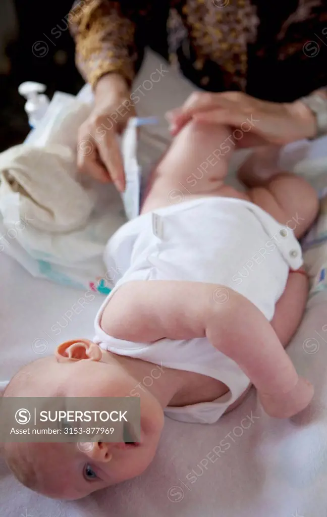 baby girl on the changing table, diaper change