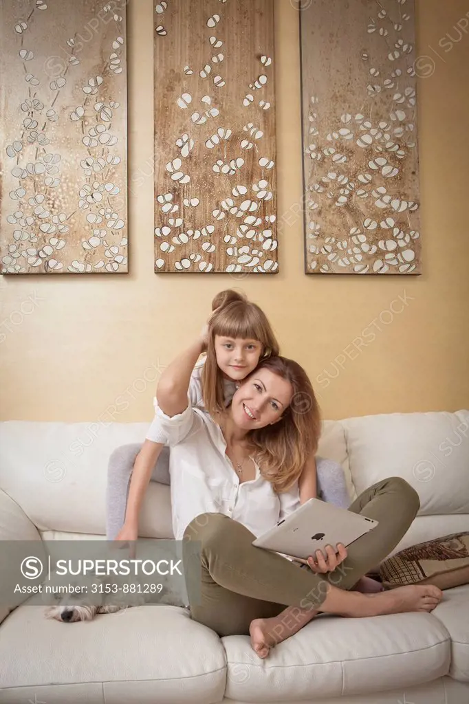mother and daughter on couch with iPad