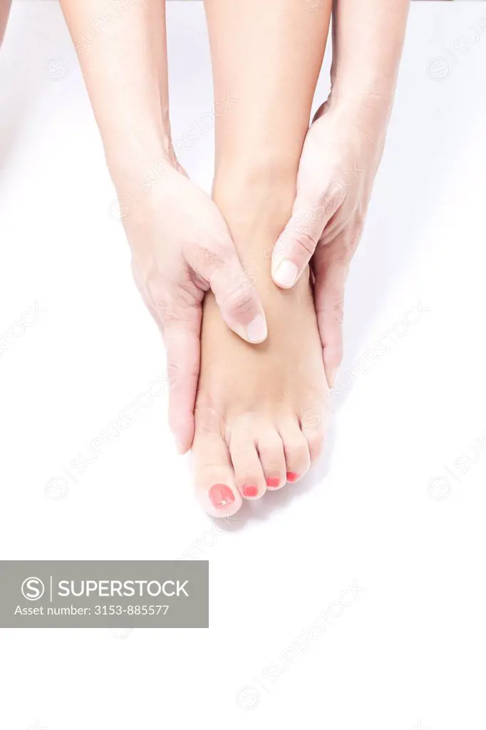 woman massaging feet