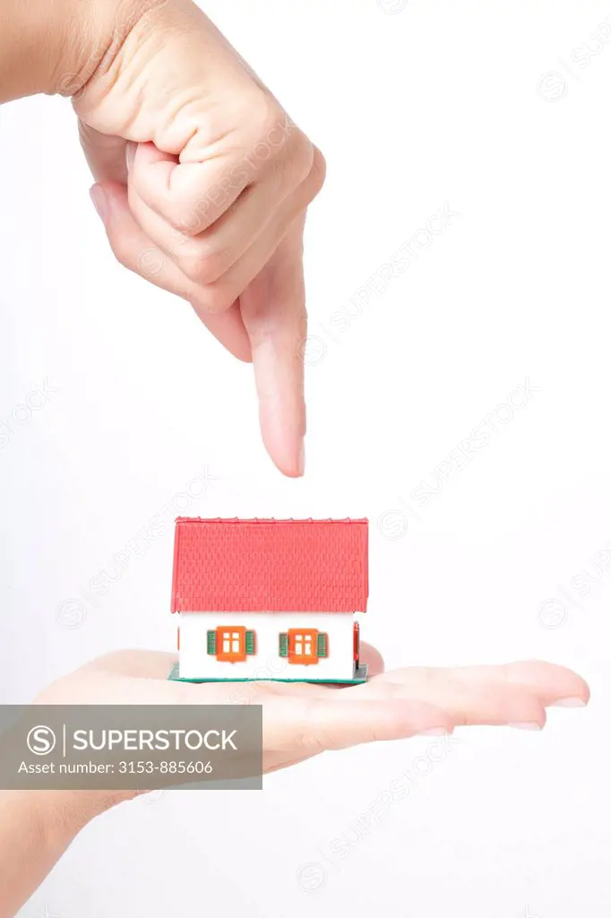 hand of a woman with small house