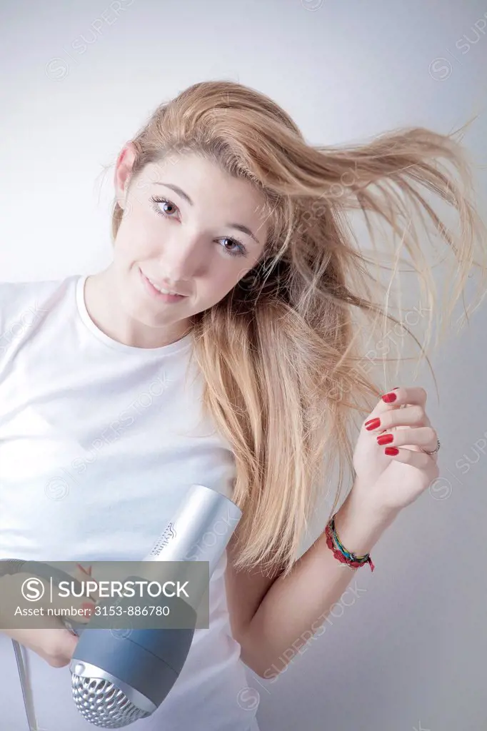 teenage girl drying the hair