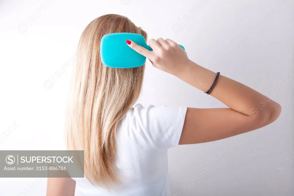 teenage girl brushing the hair