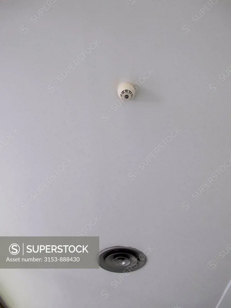 smoke detector and air diffuser on ceiling